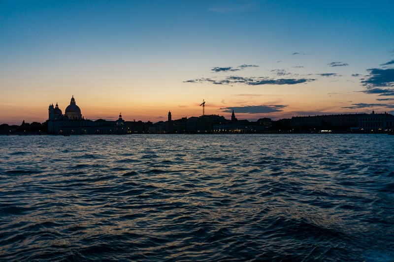 Venice skyline at sunset over rippling water