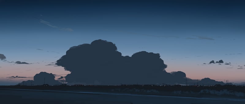 Dark clouds over a distant landscape at dusk