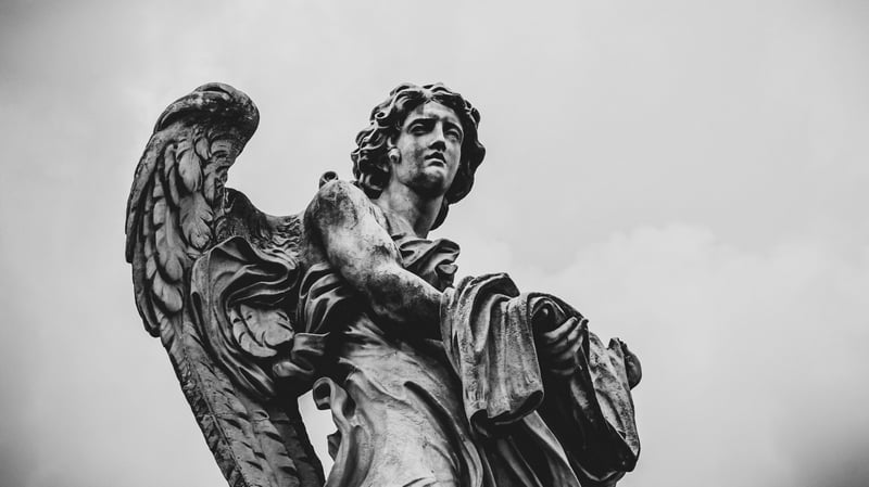 Monochrome low-angle shot of an angel sculpture