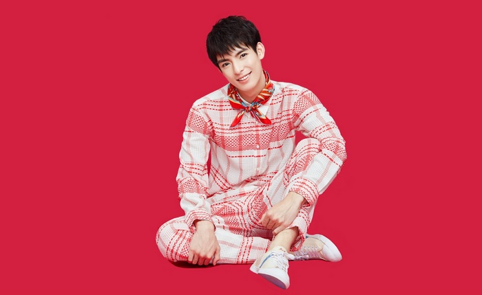 Wang Hao Xuan sitting on red background