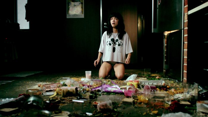 Shocked woman kneeling on messy kitchen floor in Saccharine