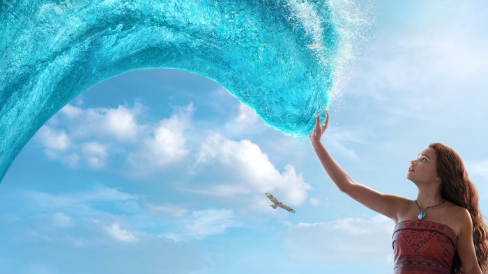 Live-action Moana touching an ocean wave