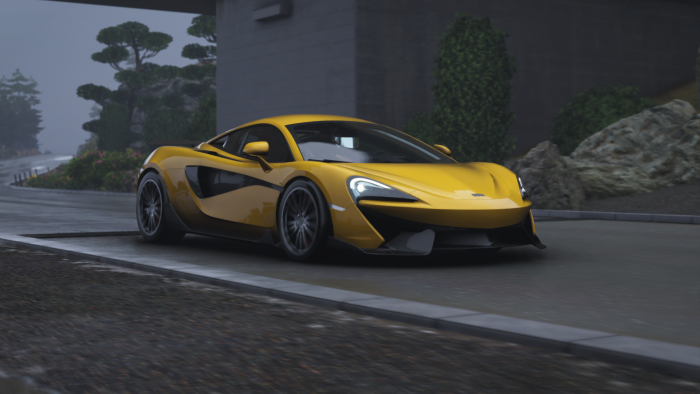 Yellow McLaren sports car on a wet road