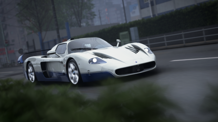 White and Blue Maserati MC12 Driving on Road