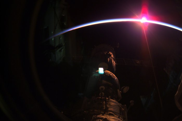International Space Station with Sunrise over Earth's Horizon