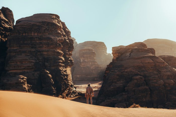 Man standing among sandstone rock formations in Hisma Desert