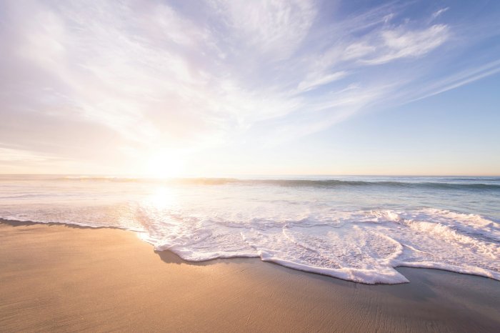 Sunrise Over a Sandy Beach with Ocean Waves