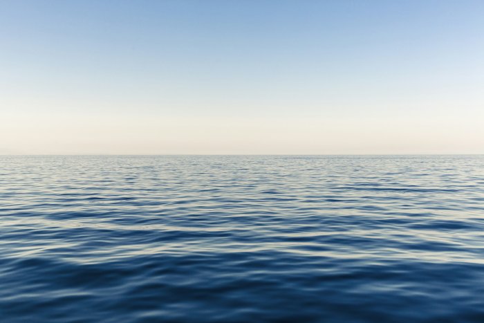 Calm blue ocean water under a clear sky