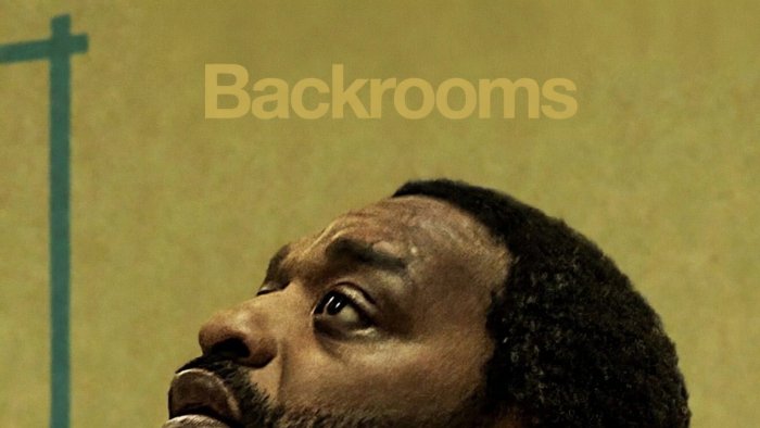 A man looking upwards in the Backrooms movie poster