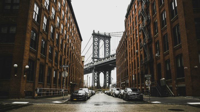 Manhattan Bridge framed by brick buildings in DUMBO