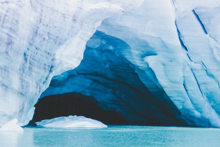 Glacier Ice Cave Over Turquoise Water