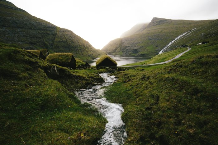 Grassy hills and stream in Saksun, Faroe Islands