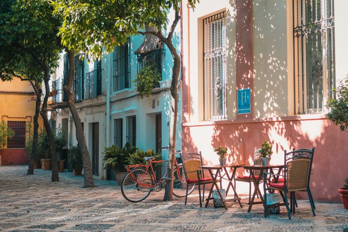 Red bicycle and outdoor cafe in Seville street