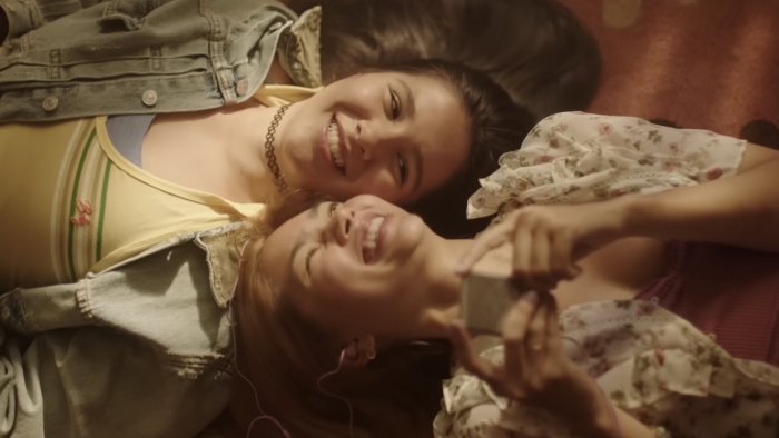 Two young women smiling in Girls Like Girls