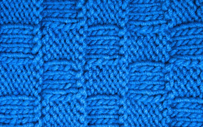 Blue knitted basketweave pattern fabric texture