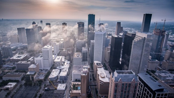 Drone view of skyscrapers shrouded in morning fog