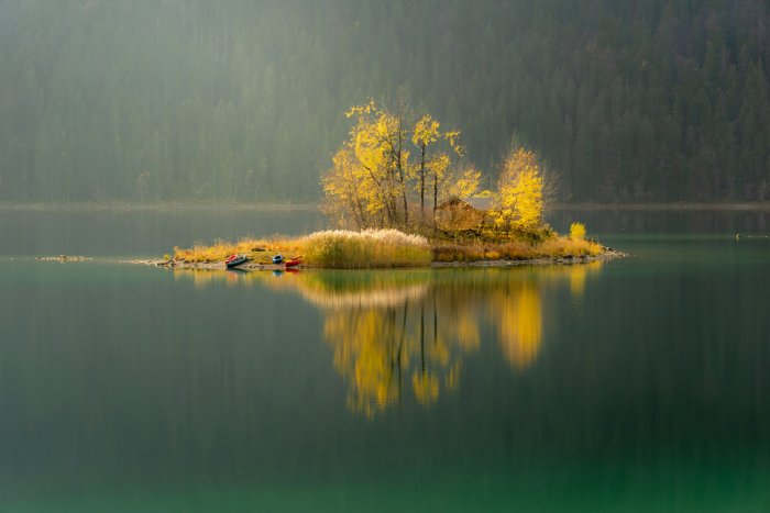 Small island with yellow autumn trees on Eibsee
