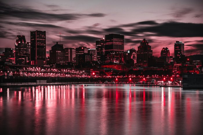 Montreal City Skyline with Red Lights and Water Reflection