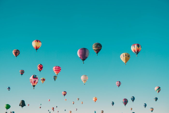 Colorful hot air balloons floating in a clear blue sky