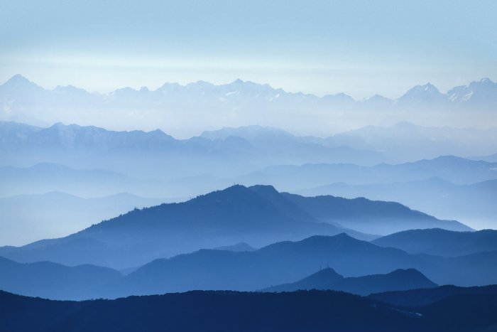 Layered Blue Mountain Ridges in Morning Mist