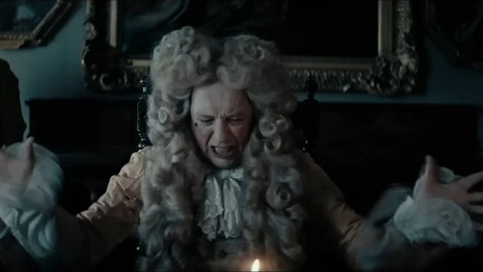 Angry character in historical wig from Savage House