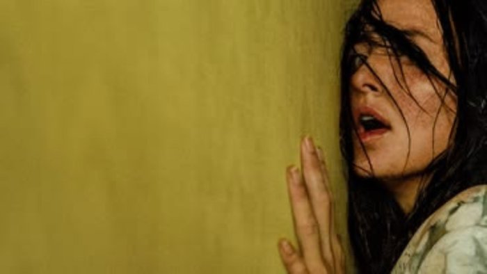 Terrified woman against a yellow wall in Backrooms