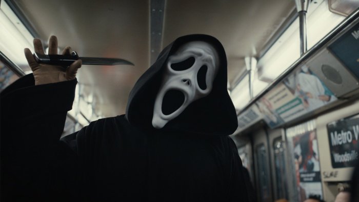 Ghostface holding a knife in a subway from Scream VI