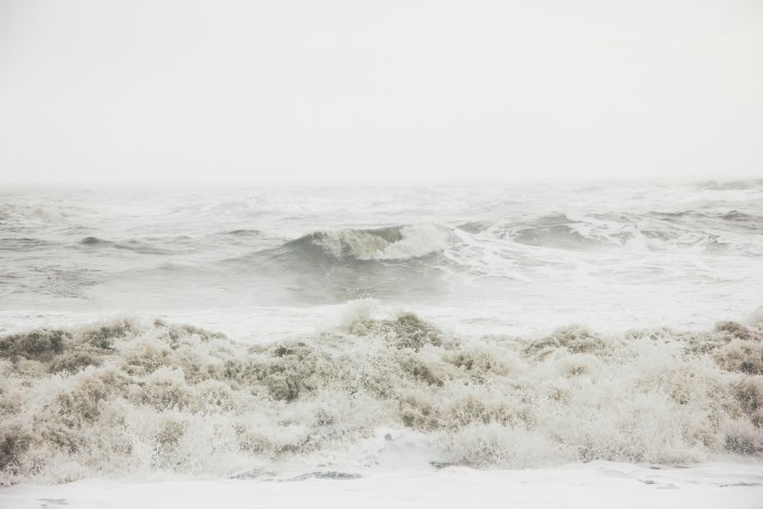 Rough sea waves under an overcast sky