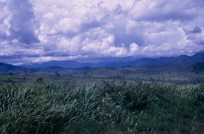 Lush Green Hills and Mountains under Cloudy Sky