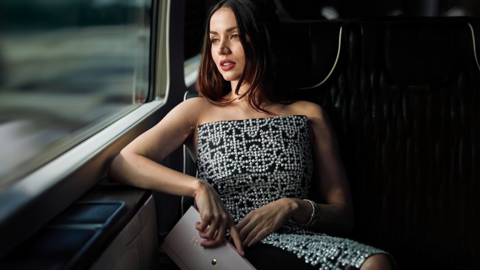 Actress Ana de Armas sitting by a window