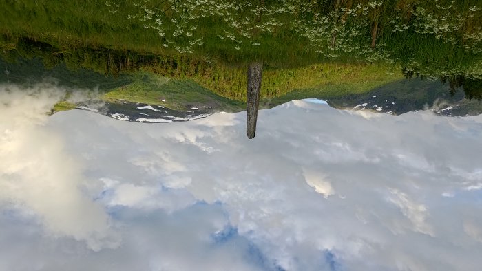 Upside Down Mountain Landscape with Wooden Post
