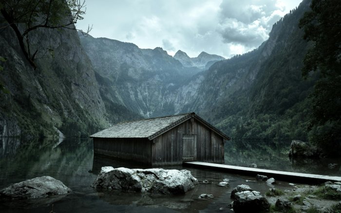 Wooden boathouse on a calm mountain lake
