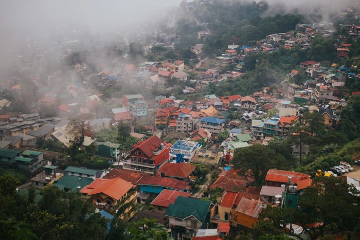 Misty Hillside Town with Colorful Houses