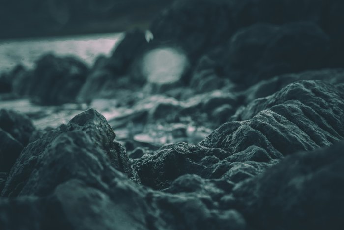 Close-up of dark textured blue rock formations