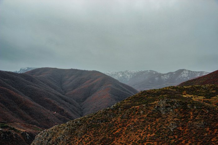 Mountain ranges under a cloudy overcast sky