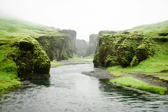 River flowing through mossy green canyon