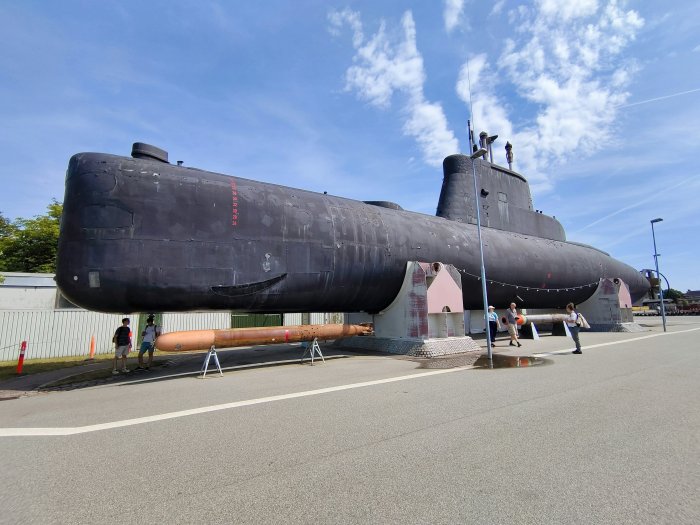 Large Black Submarine on Display Outdoors