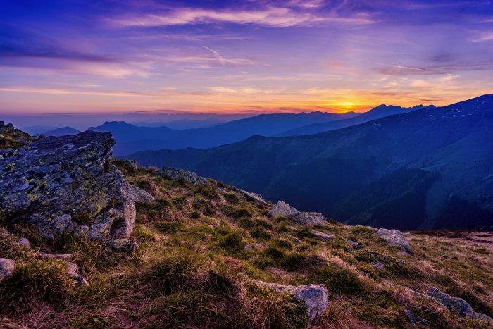 Mountain landscape during sunset with purple sky