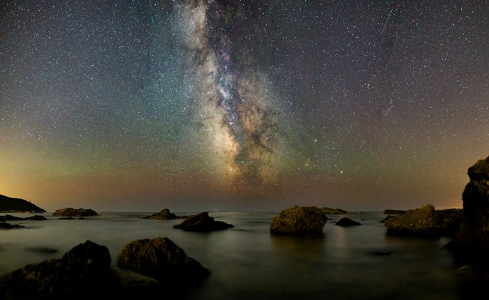 Milky Way Galaxy Over Rocky Sea Coast at Night