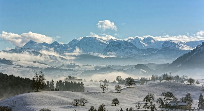Snowy Swiss Winter Landscape with Mountains and Mist