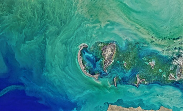 Satellite view of islands in swirling turquoise water