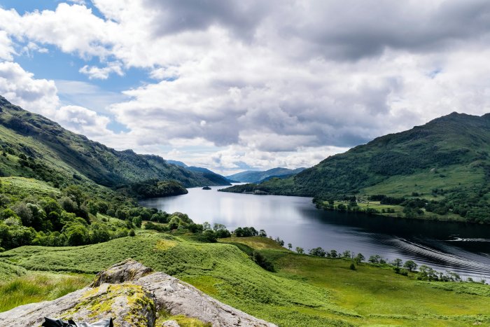 Scenic view of a lake winding through green mountains