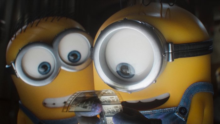 Minions looking closely at a film strip