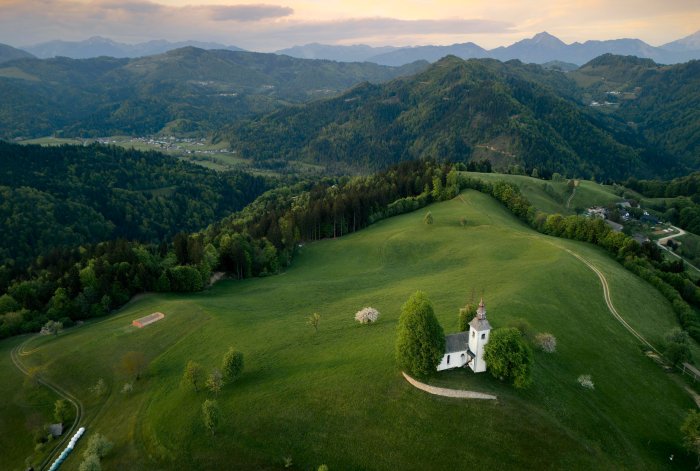 Slovenian Church on a Lush Green Hillside