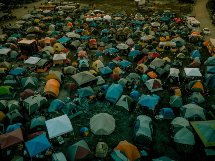 Aerial view of a crowded campsite with colorful tents