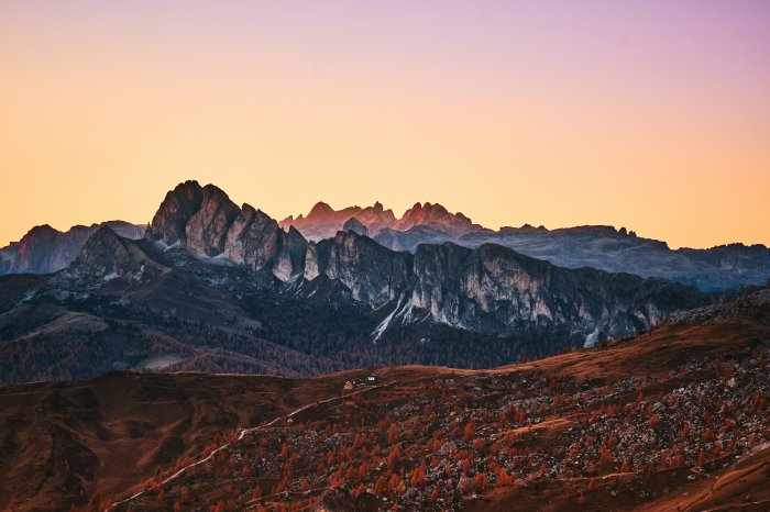 Mountain range during sunset with autumn trees