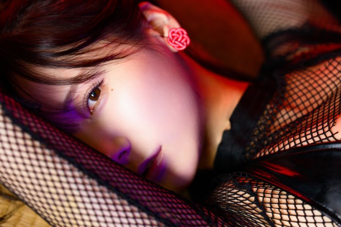 Close-up of a woman in black fishnet clothing