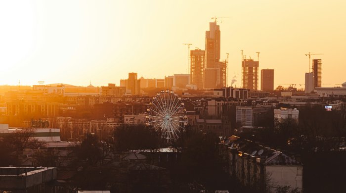 City skyline with a Ferris wheel at sunset