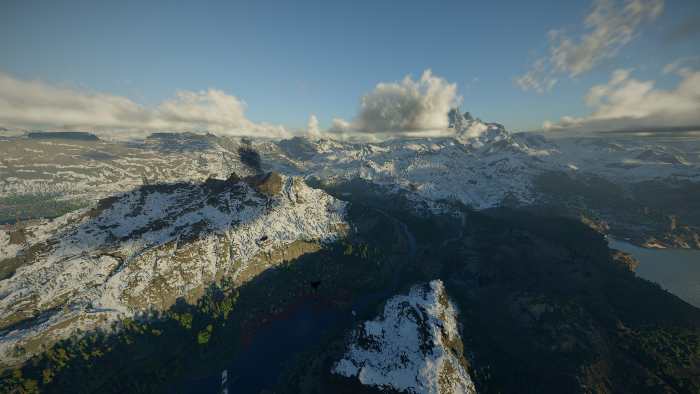 Aerial View of Snowy Mountain Range and River Valley