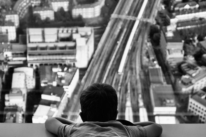 Child looking down at a city